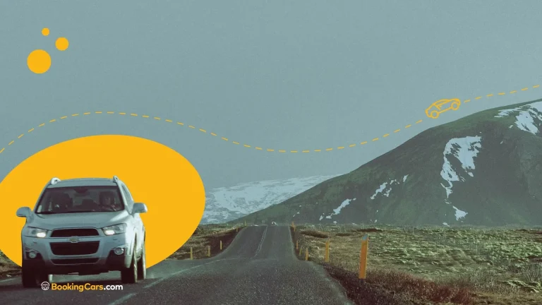 Auto recorriendo una ruta escénica rodeada de montañas nevadas en Tierra del Fuego.