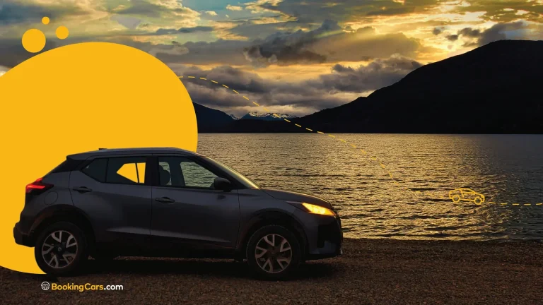 SUV negra estacionada frente a un lago al atardecer con gráficos amarillos.